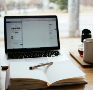 MacBook Pro near white open book