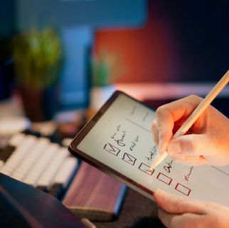 Someone is writing on a tablet with a stylus.